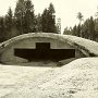 Bombproof hangar in forest.